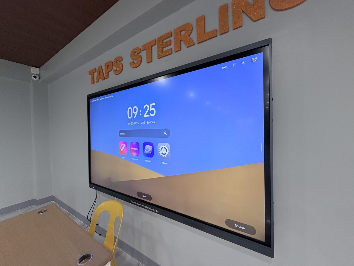 Large wall-mounted interactive touchscreen display in the seminar room showing its home screen.